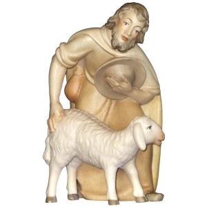 Pastore piegato con pecora